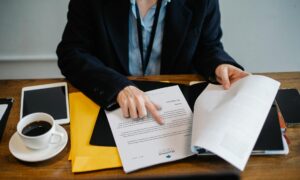 crop businesswoman working with documents in office