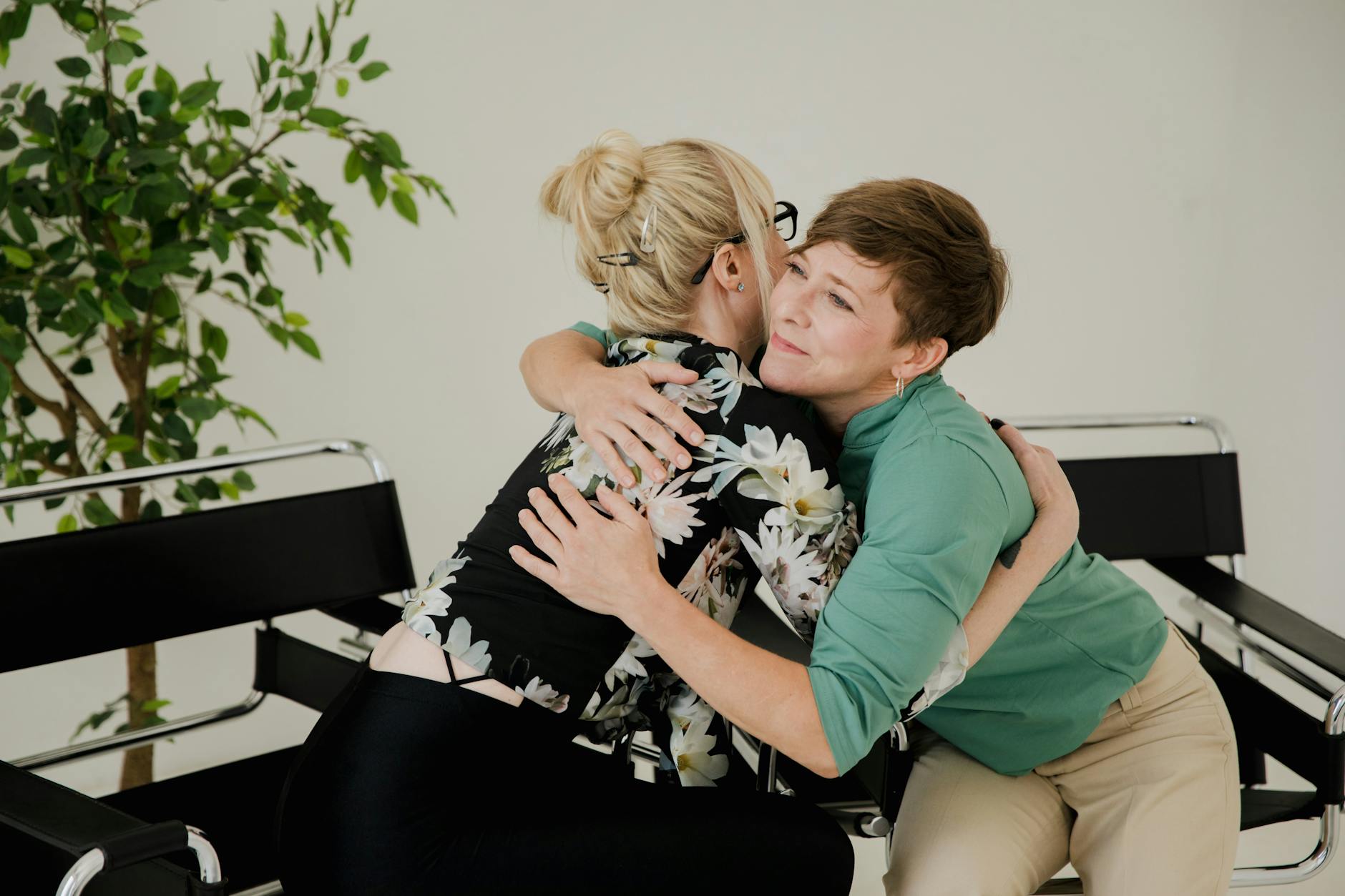 women hugging in a therapy office